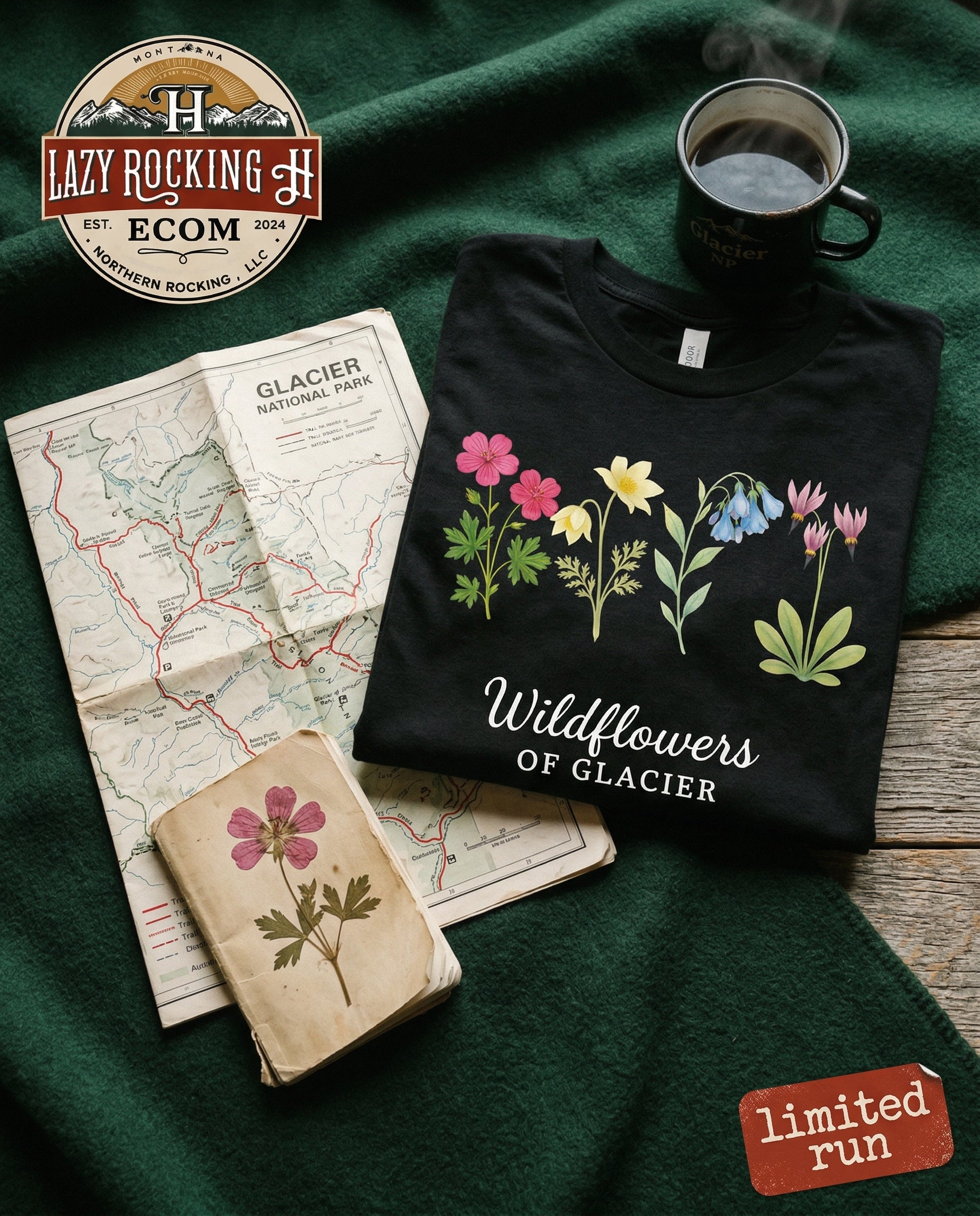 Black t-shirt with floral design and text, placed on a green surface with a map and coffee cup.